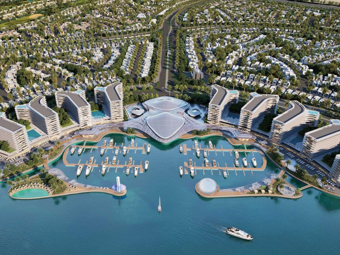 Aerial view of a modern beachfront resort with unique, curved buildings, numerous pools, two marinas, and a densely built residential area nearby.