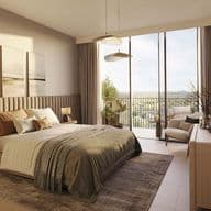 Modern bedroom in Distrikt apartment with balcony overlooking Ghaf Woods community landscape.