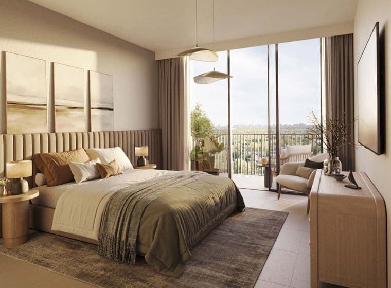 Modern bedroom in Distrikt apartment with balcony overlooking Ghaf Woods community landscape.