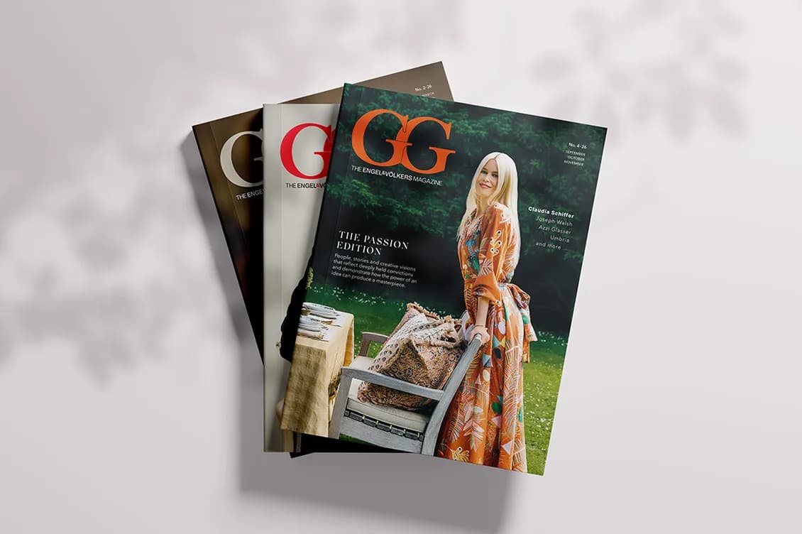 Fanned stack of GG magazines; front cover features a smiling woman in an orange floral dress outdoors beside a table and chairs.