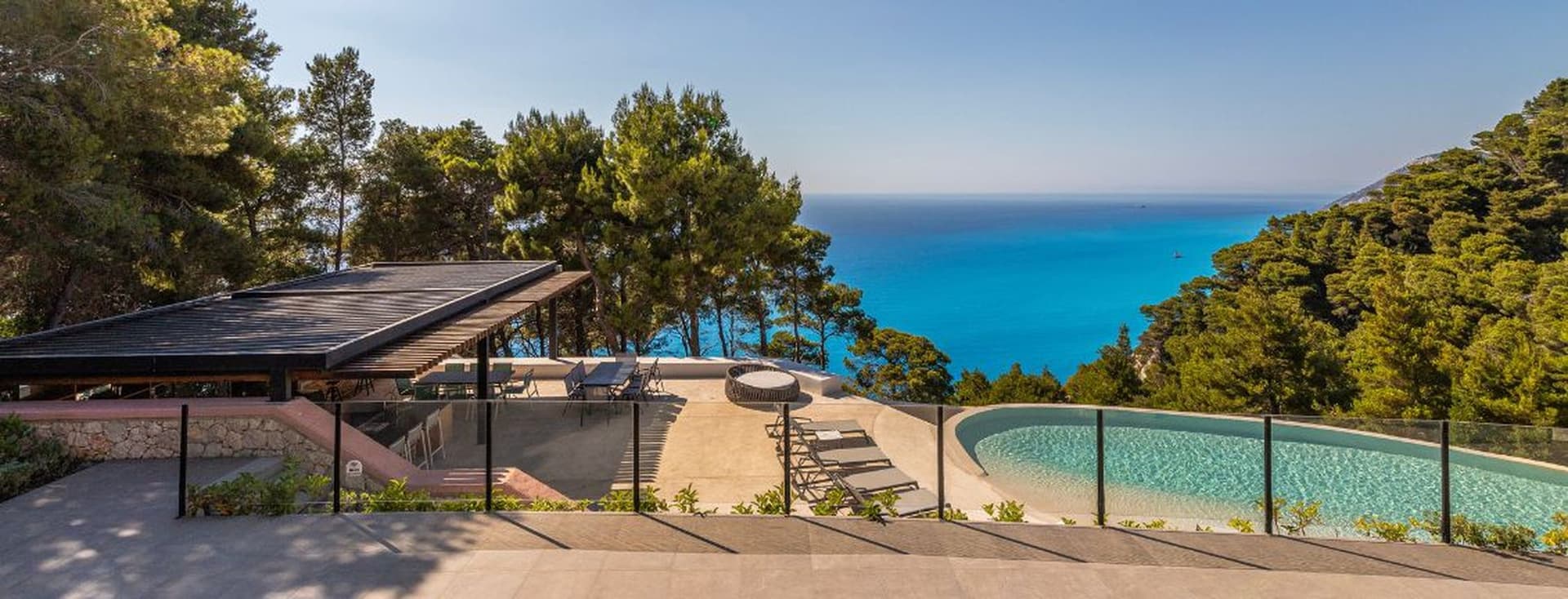 Luxury seaside villa with infinity pool, panoramic sea views, and lush natural surroundings