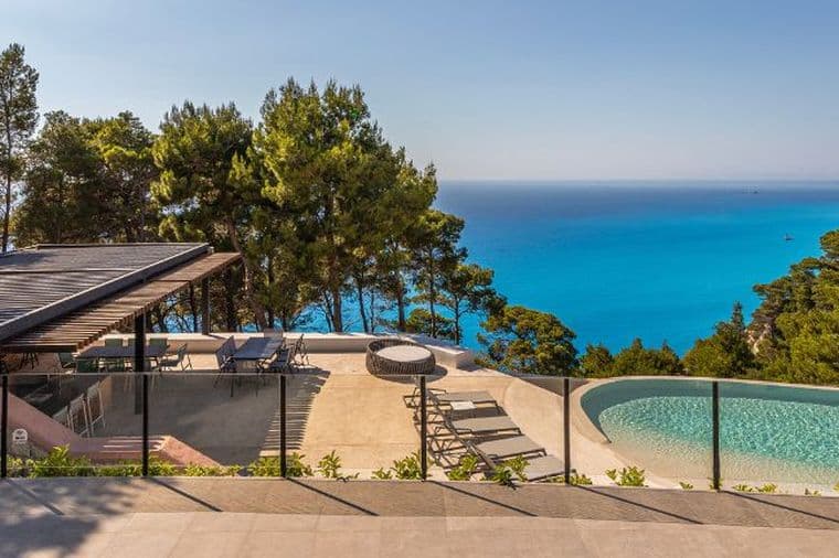 Luxury seaside villa with infinity pool, panoramic sea views, and lush natural surroundings