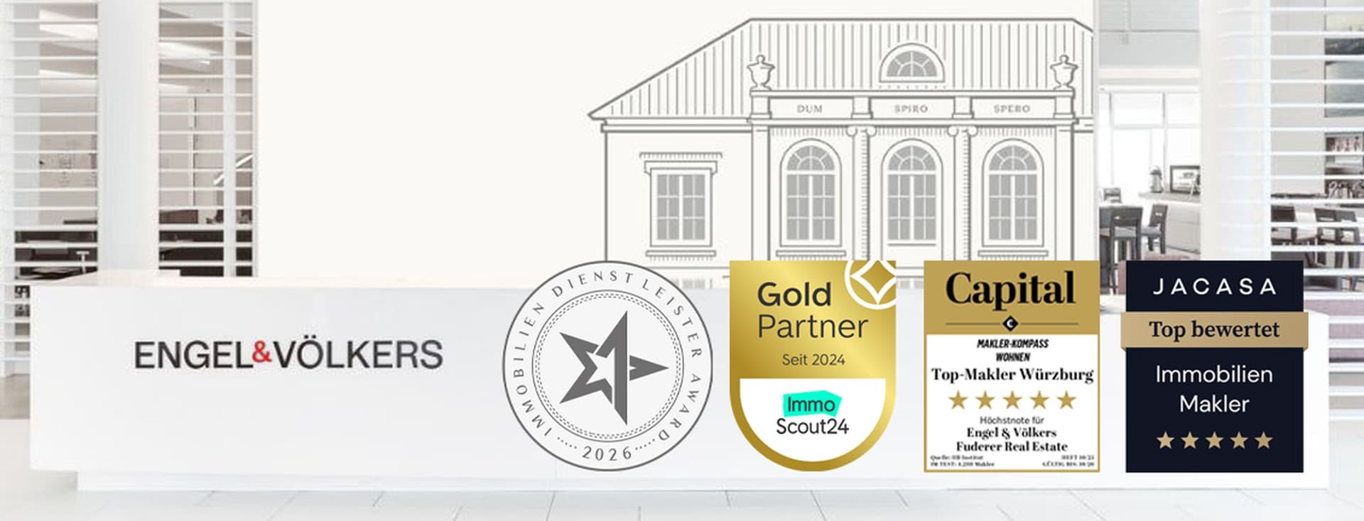 Engel & Völkers office interior with awards displayed in the foreground and an architectural line drawing in the background.