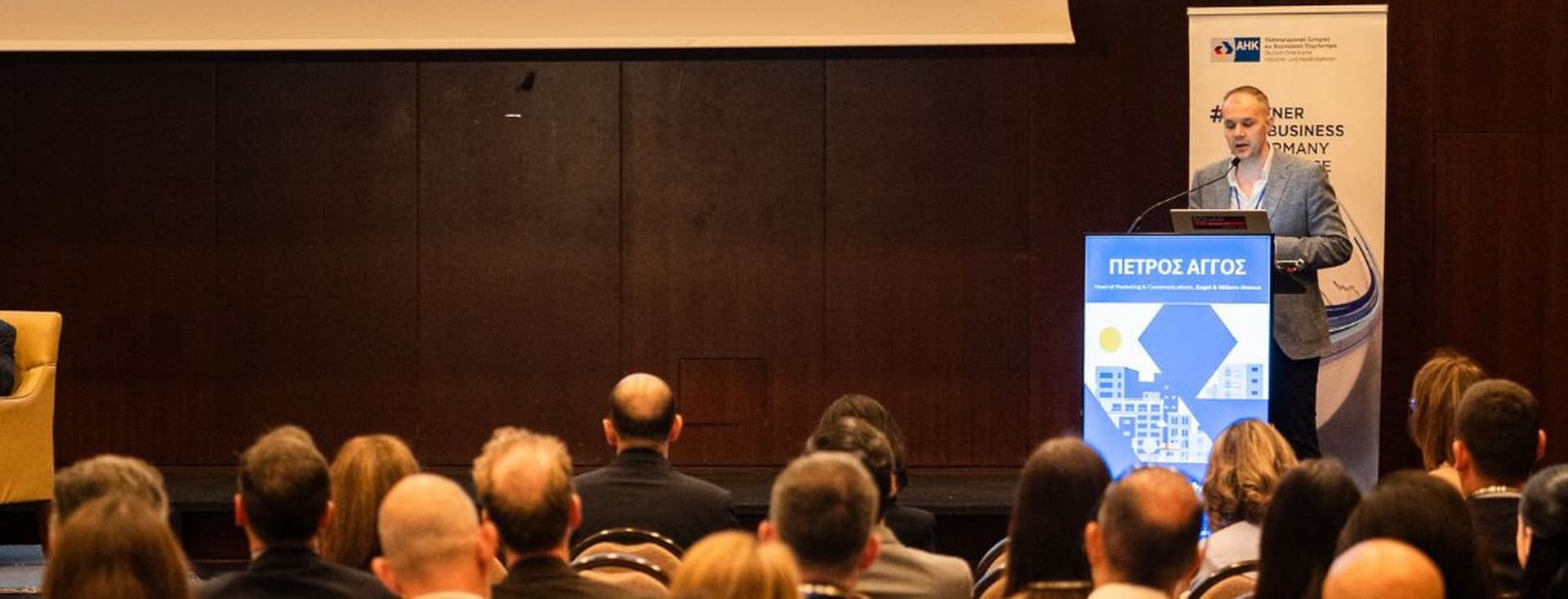 Conference speaker presenting to an audience at a real estate industry event.