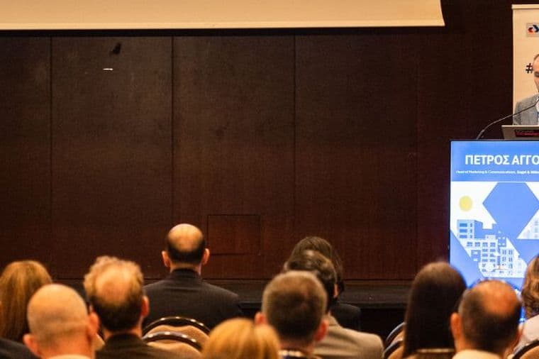 Conference speaker presenting to an audience at a real estate industry event.