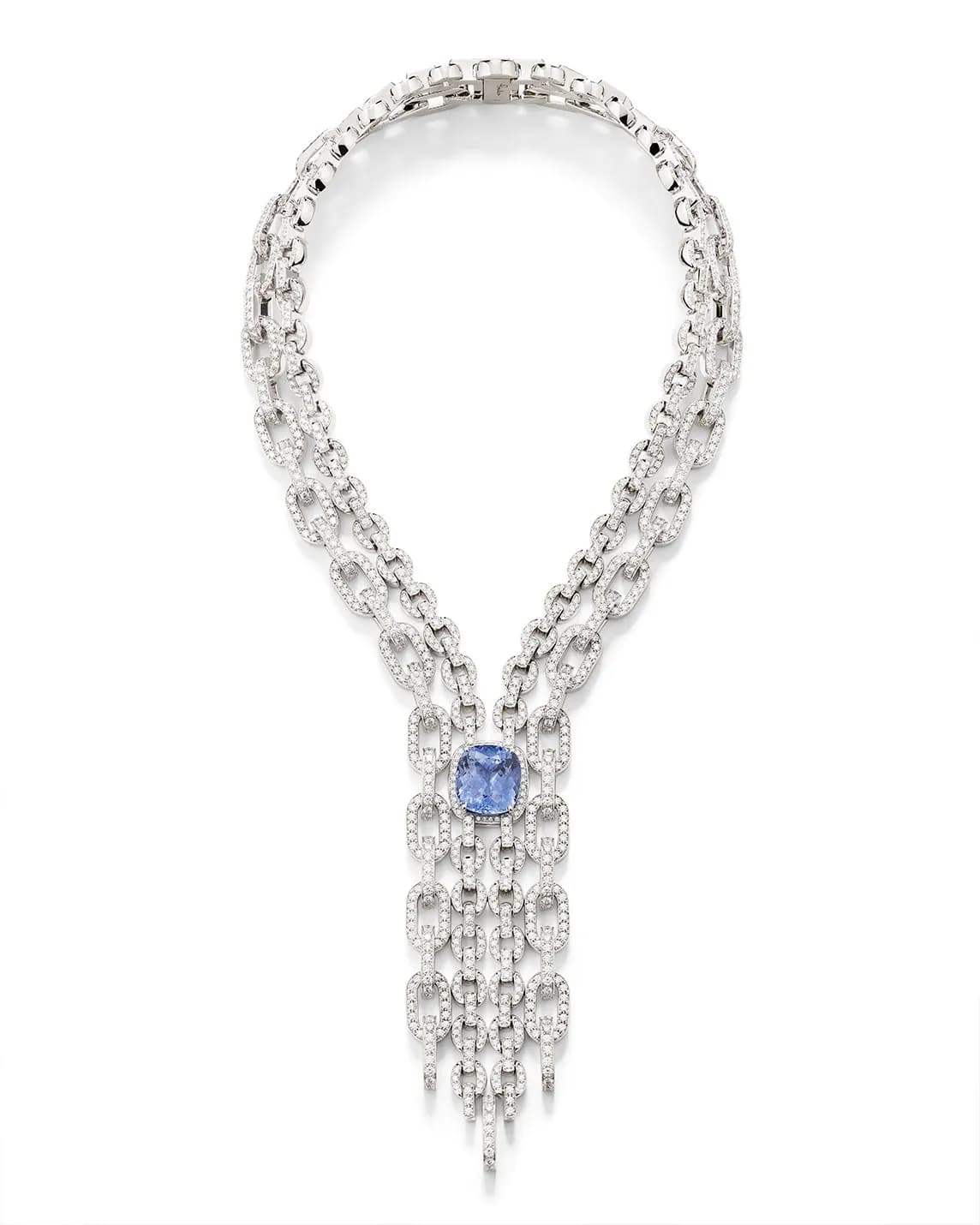 Diamond necklace with thick pave-link chains, a central blue gemstone, and a multi-strand diamond fringe.