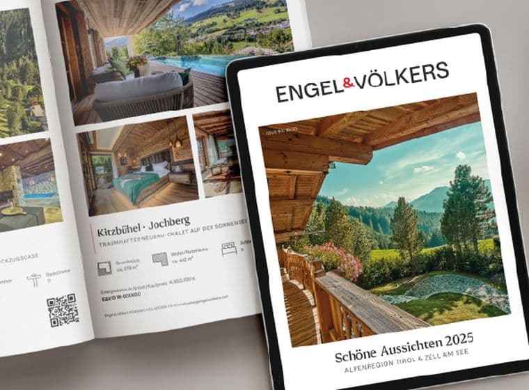 Printed and digital property catalogue by Engel & Völkers featuring alpine luxury real estate – displayed open on a table next to a cup of cappuccino and a tablet showing the catalogue cover “Beautiful Prospects 2025 – Alpine Region Tyrol & Zell am See”