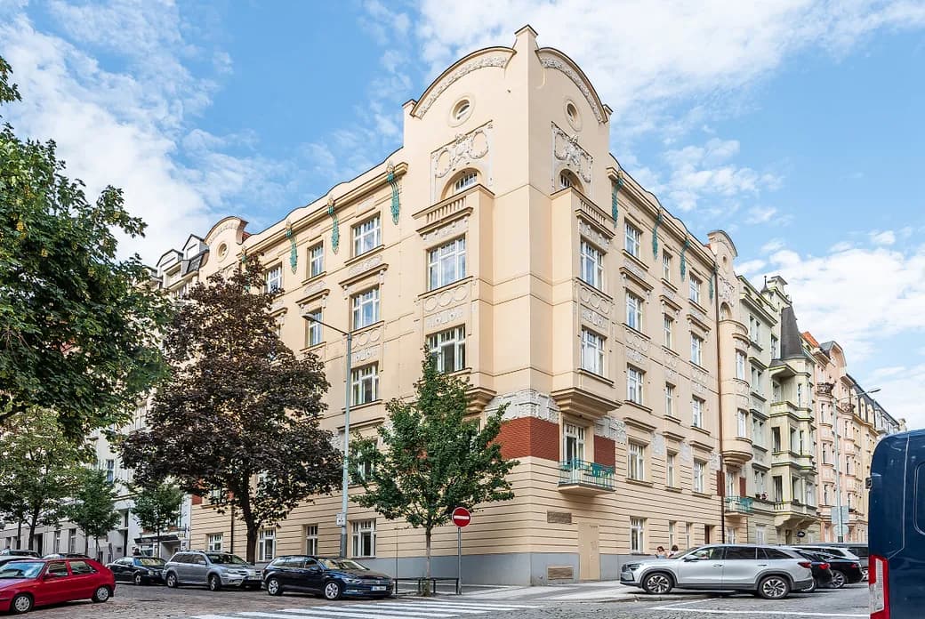 Historic corner building of Residence Polská with an ornate light-coloured façade in Prague’s Vinohrady district.