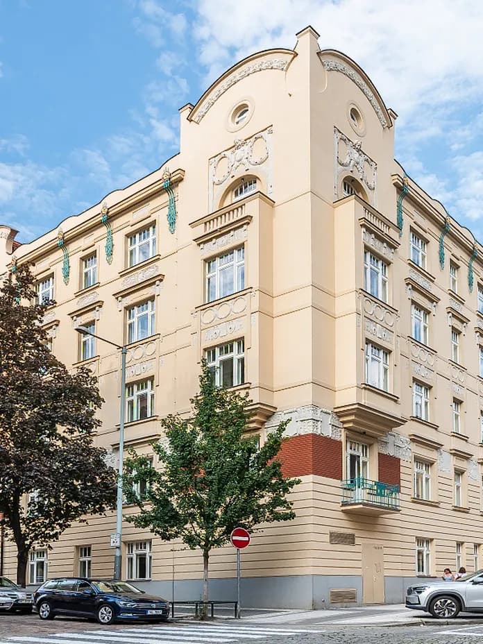 Historic corner building of Residence Polská with an ornate light-coloured façade in Prague’s Vinohrady district.