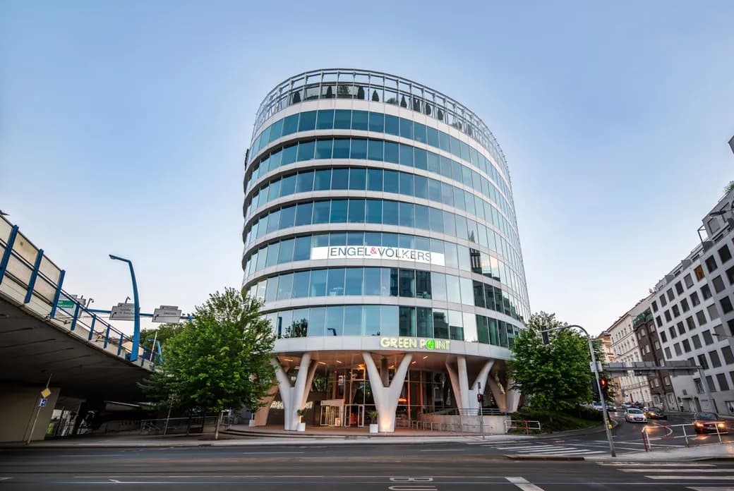 Glass-fronted Green Point office building with the Engel & Völkers logo, viewed from the street.