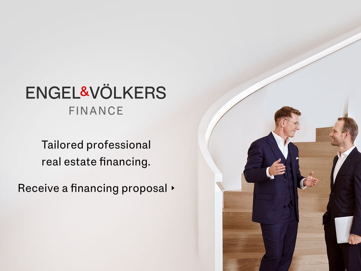 Two men in suits having a conversation on a staircase; text mentions Engel & Völkers Finance and real estate financing services.