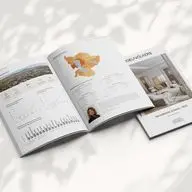 Open Engel & Völkers market report with charts, maps, and a property photo on a white surface with leaf shadows.