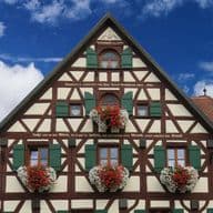 Newly renovated, heritage multi-family house with half-timbering and flower boxes