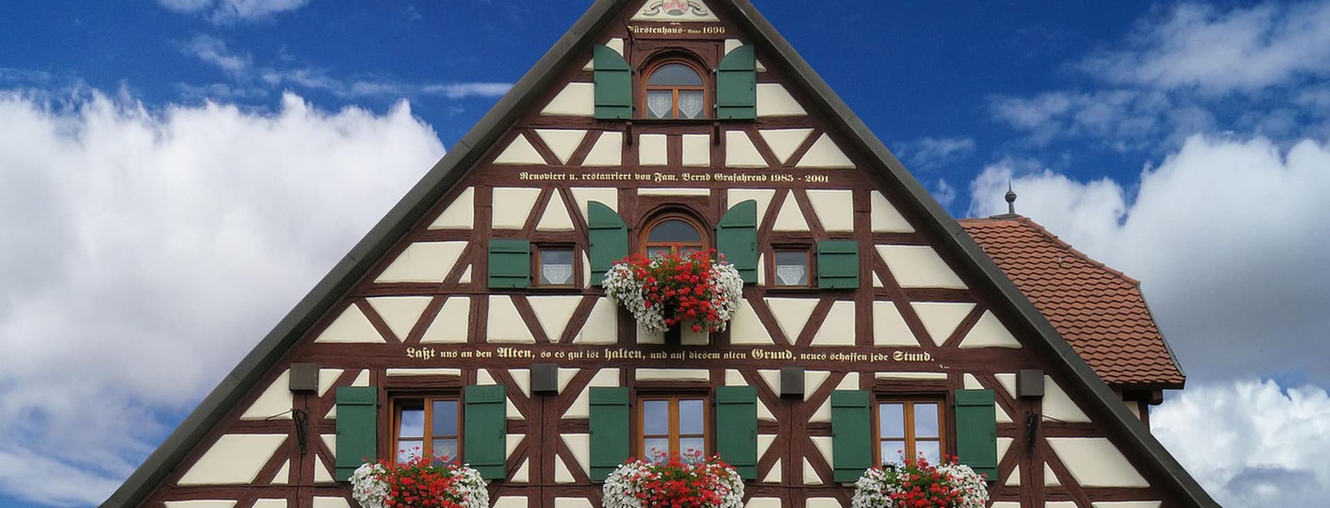 Newly renovated, heritage multi-family house with half-timbering and flower boxes