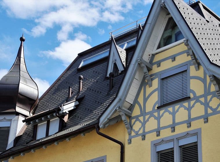 View from the outside of the top floor of a yellow apartment building