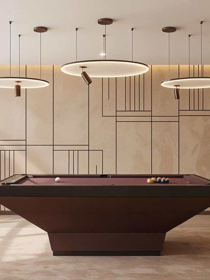 Modern room with a sleek pool table, geometric wall patterns, and circular pendant lights hanging from the ceiling.