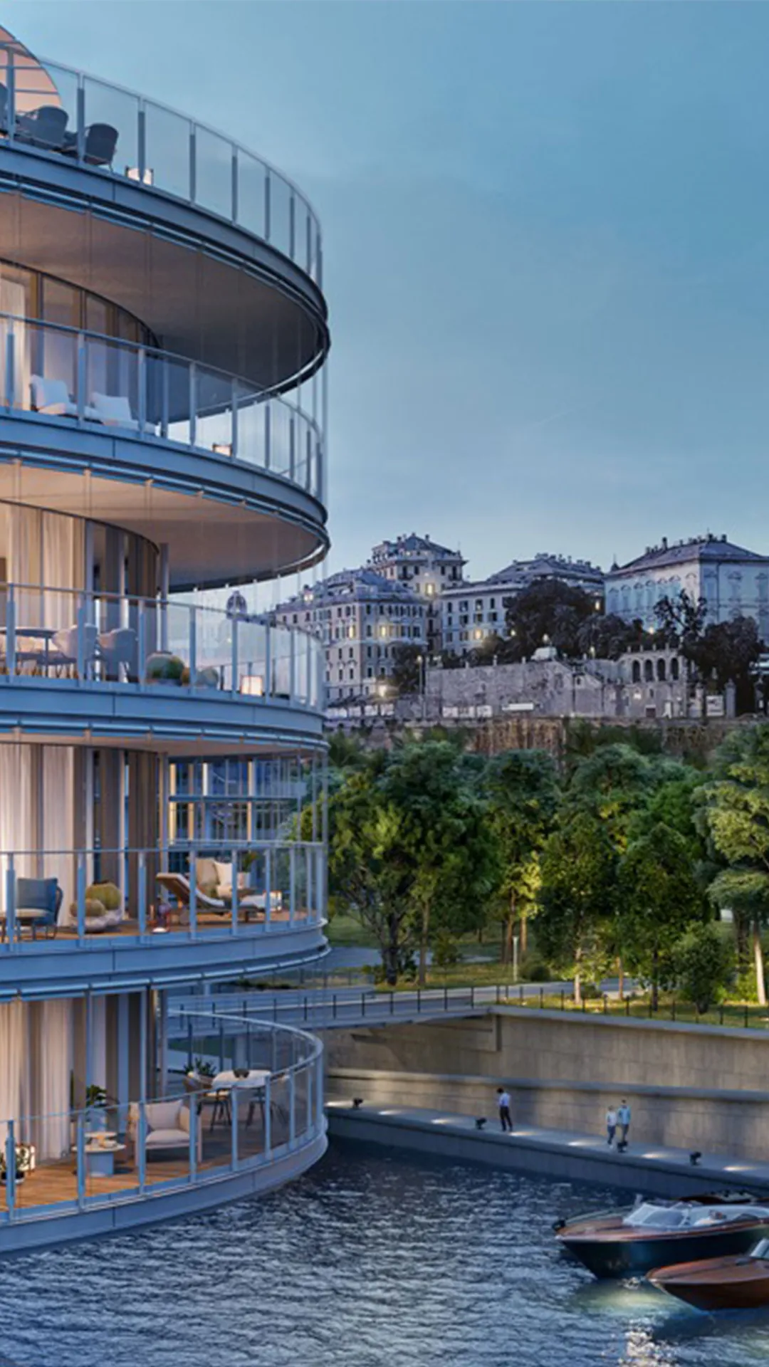 Curved glass apartment building with balconies overlooking a river; a small boat dock and historic hillside buildings in the distance.