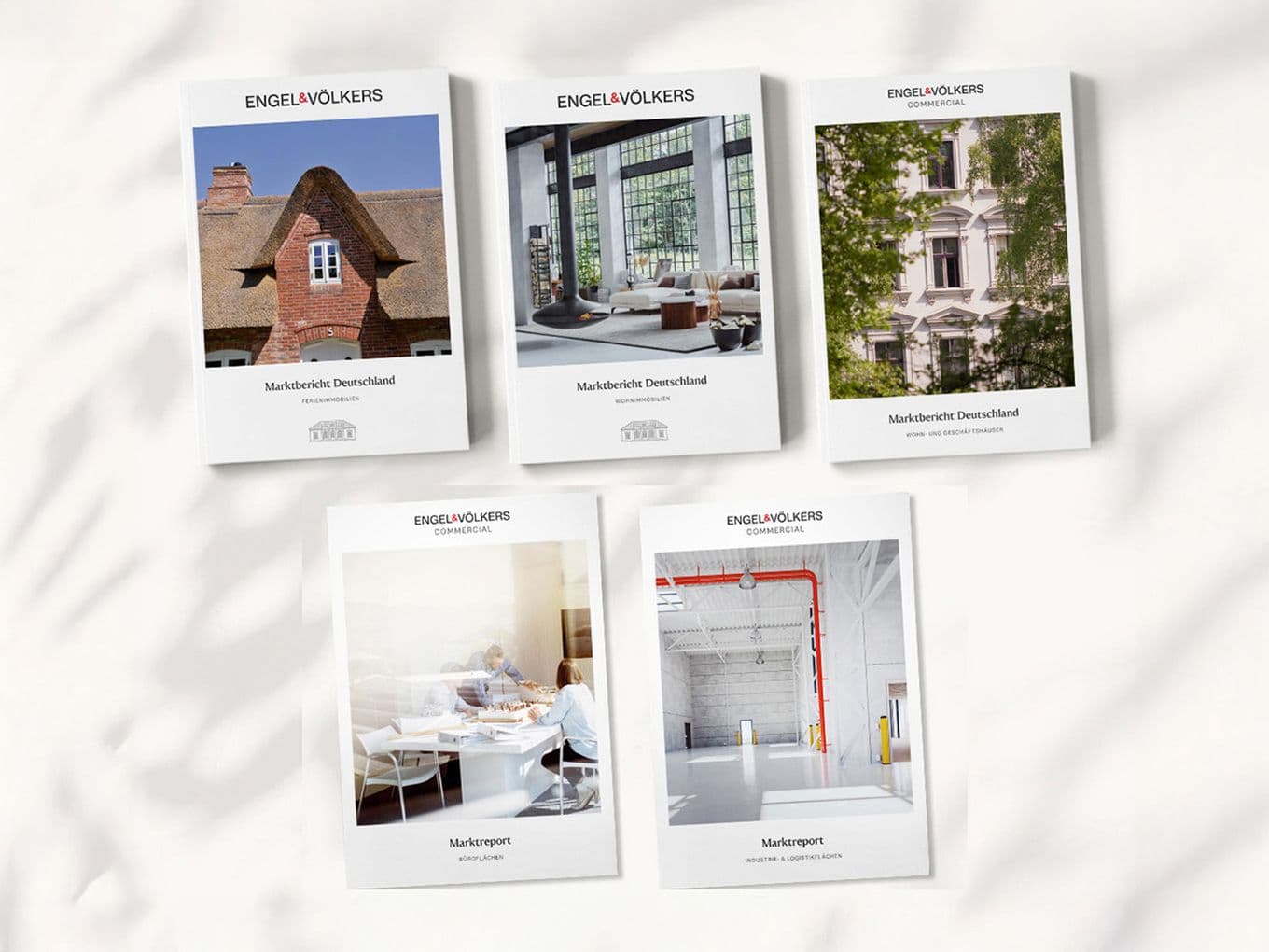 The image shows the cover pages of several different market reports from Engel & Völkers Research.