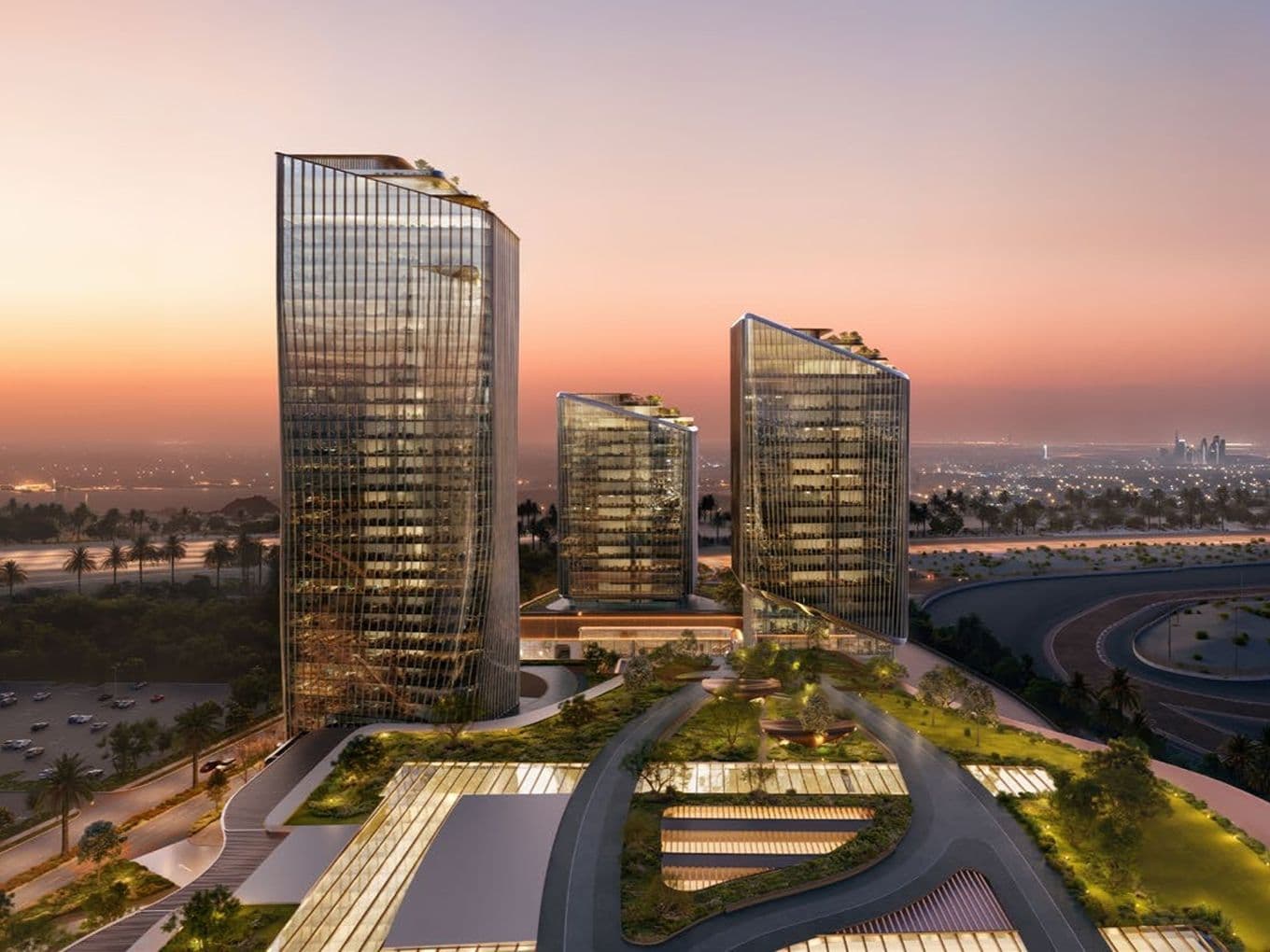 Three modern curved glass towers with rooftop gardens above landscaped terraces, city skyline glowing at sunset