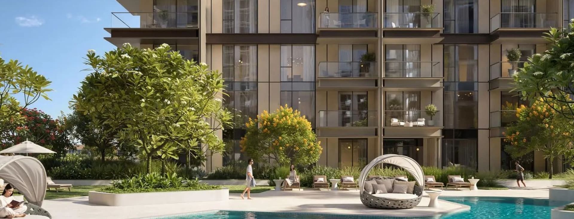 Modern apartment building with glass balconies, trees, and a pool. People are swimming and relaxing around the pool on a sunny day.