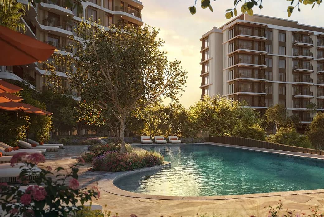 Sunset over a resort-style apartment complex with a curved turquoise pool, lounge chairs, and modern high-rise buildings. AI-generated image