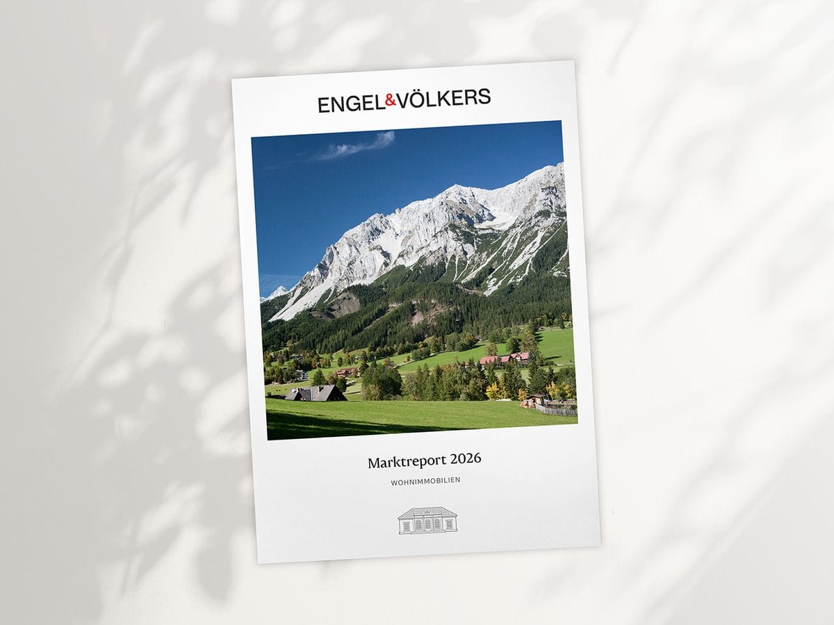 Engel & Völkers report cover showing alpine landscape: green valley, chalets, forest and snow‑capped mountains, titled "Marktreport 2026".