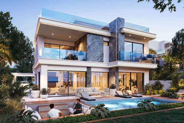 Modern two-story house with large windows, a pool, and outdoor seating area. People relax by the pool surrounded by lush greenery at dusk.