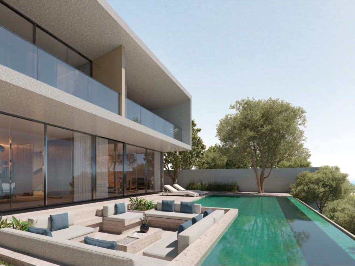 Modern villa with glass facade, infinity pool, and sunken outdoor seating surrounded by trees under a clear sky.