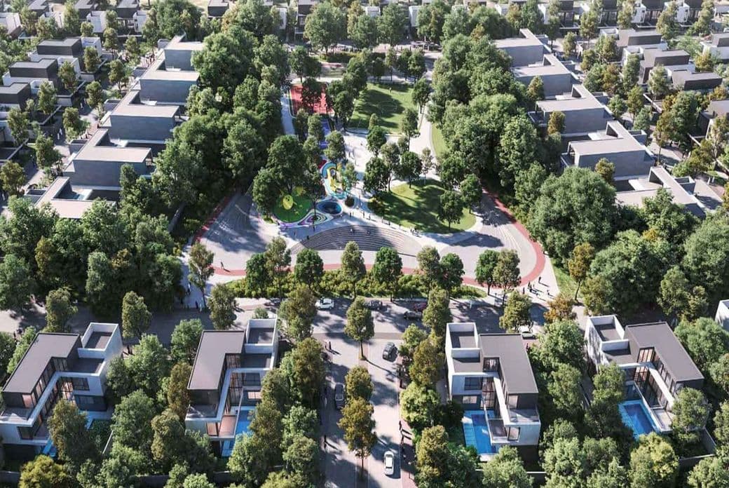 Aerial view of a suburban neighborhood with houses, a central park featuring a winding path, colorful playground, and lush trees.