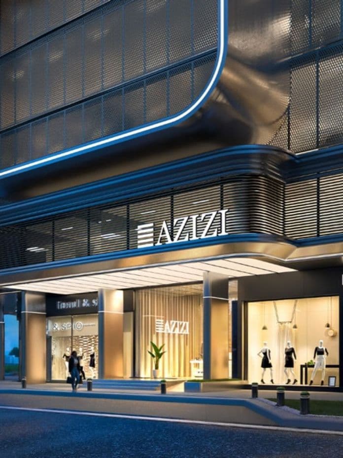 Modern building exterior with bright storefronts, including a fashion shop, at dusk; people walk on the sidewalk and a car is parked nearby.