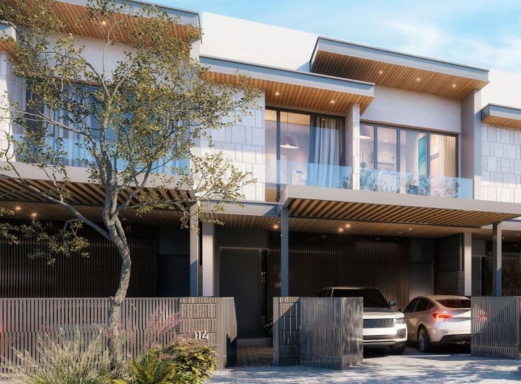 Close-up view of a contemporary 3-bedroom Pinewood Estate Home façade with two-car garage, vertical slat fencing, wood-accented soffits, and floor-to-ceiling windows.