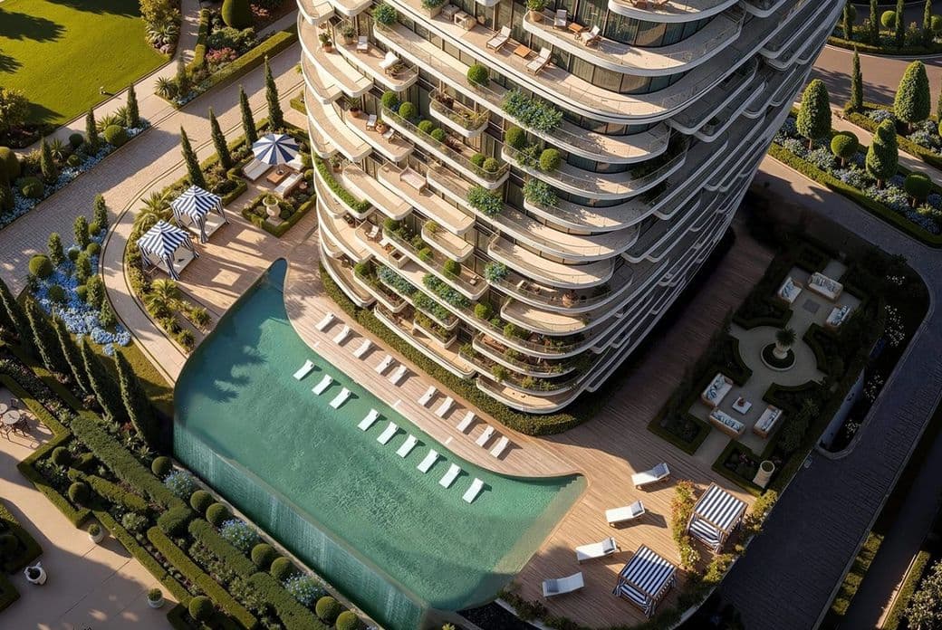 Aerial view of a luxury skyscraper with curved balconies, spacious terrace, pool with a waterfall feature, and landscaped garden.