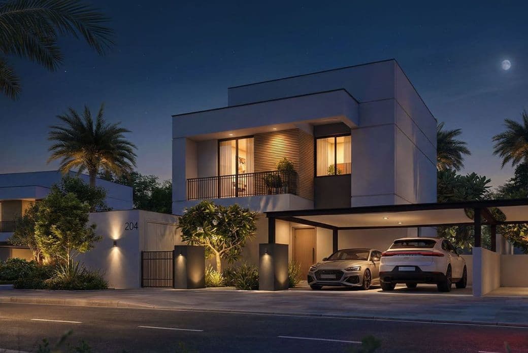 Modern house at night with palm trees, illuminated windows, and two cars parked in a driveway. A crescent moon is visible in the sky.