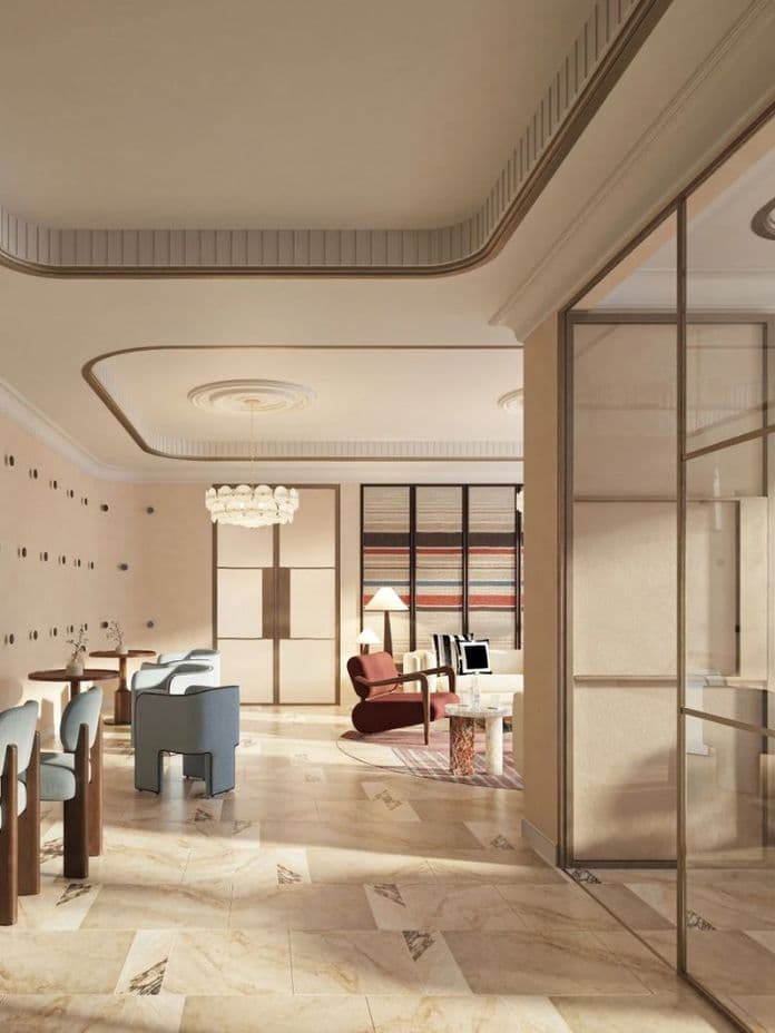 Elegant modern interior with marble floors, blue and pink chairs, a glass partition, and a mix of wooden and brass accents, well-lit by natural light.