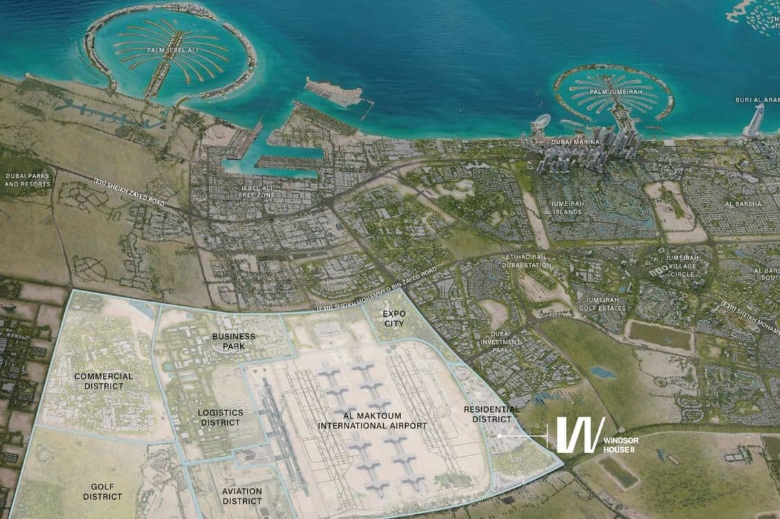 Aerial view of Dubai World Central, highlighting Al Maktoum International Airport with surrounding districts and Palm Islands in the background.