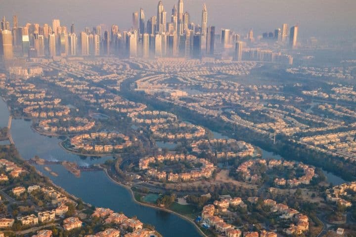 Aerial view of a misty morning in Dubai with Jumeirah Islands and Dubai Marina skyline