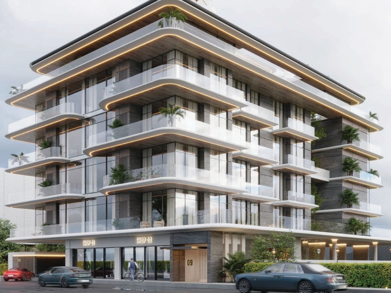 Modern multi-story building with glass balconies, lush plants, and sleek design. Ground level has shop entrances and parked cars in front.