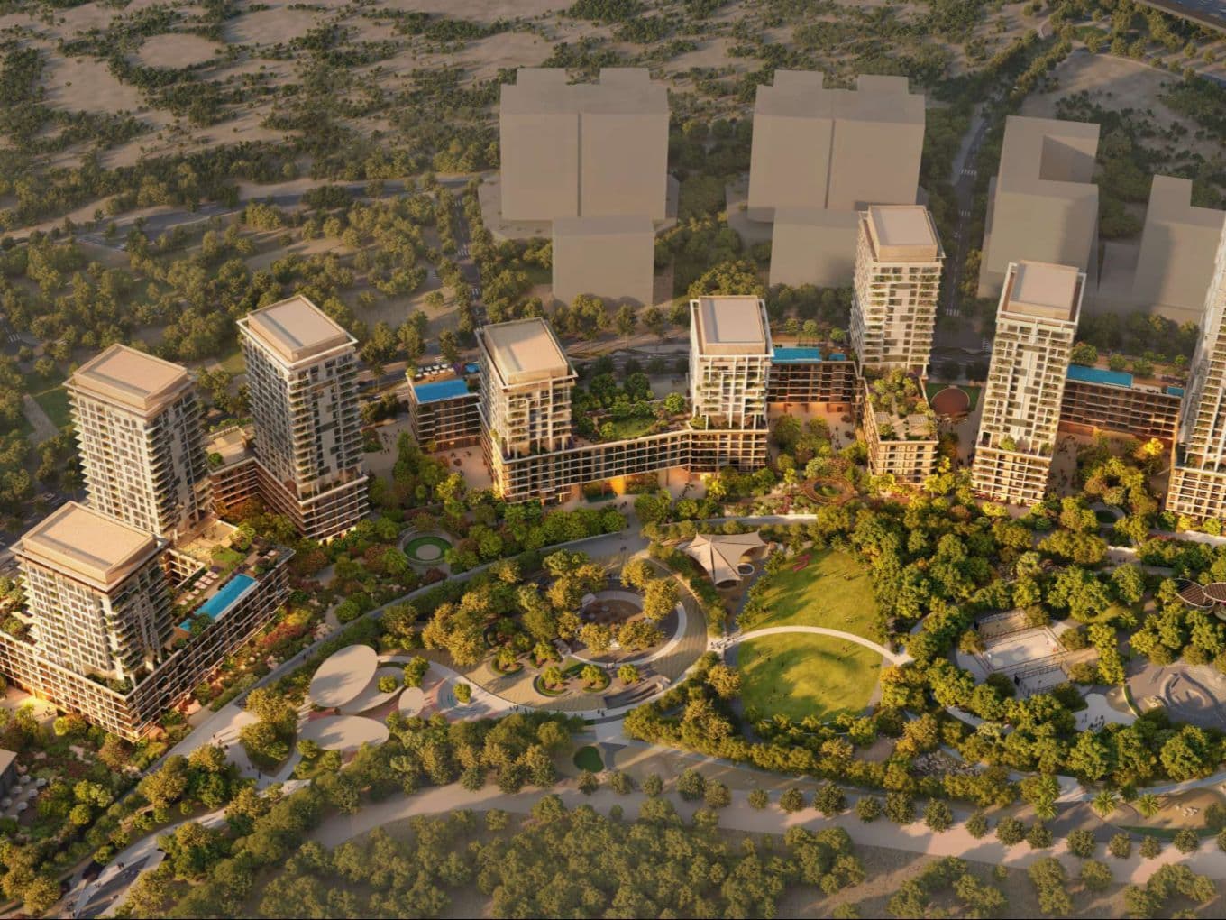 Aerial view of a sunlit residential complex: several high‑rise towers with rooftop pools set amid landscaped parklands and winding pathways.