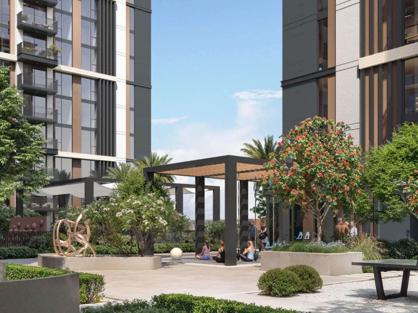 Modern courtyard with lush greenery, a central pergola, and tall buildings in the background under a clear blue sky.