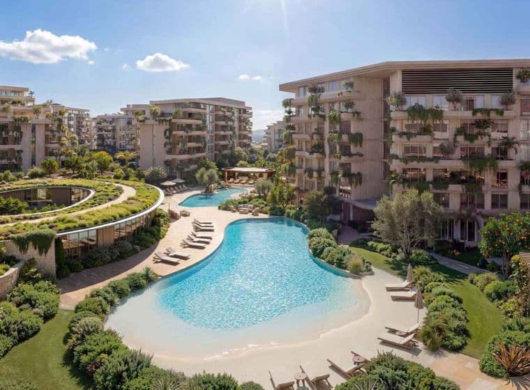 Modern apartment complex with lagoon-style pool, sandy beach edge, lounge chairs and lush landscaping
