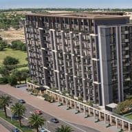 Aerial view of a modern, multi-story residential building with large windows, surrounded by palm trees and a road with passing cars.