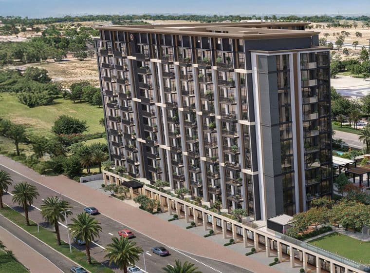 Aerial view of a modern, multi-story residential building with large windows, surrounded by palm trees and a road with passing cars.