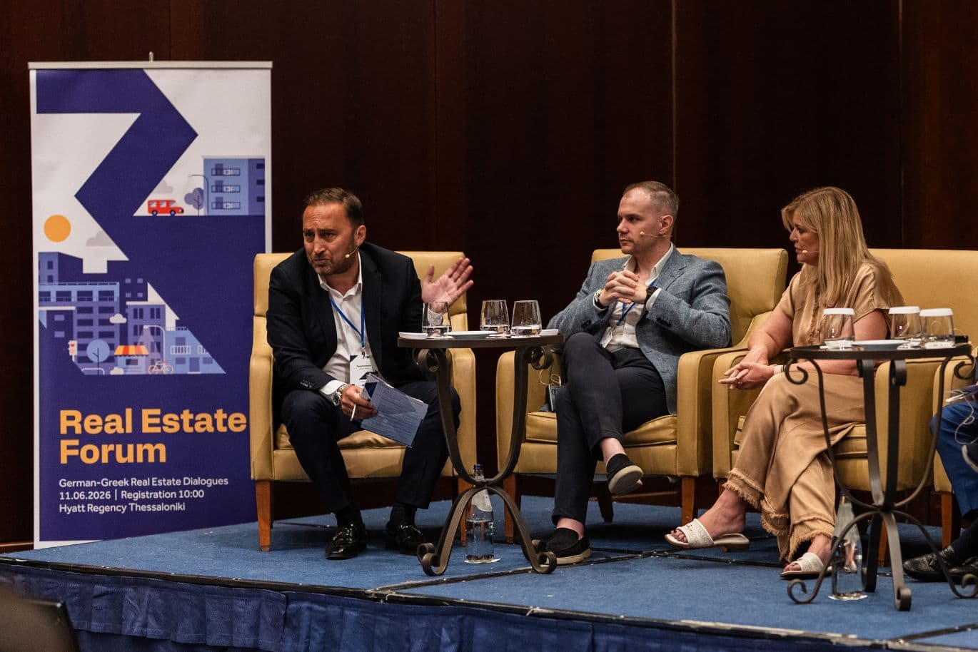 Panel discussion featuring real estate professionals at an industry forum.