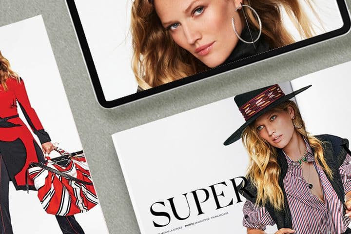 Close-up of magazines and a tablet featuring model Toni Garrn. The GG magazine cover is red and white with a photo of Toni.