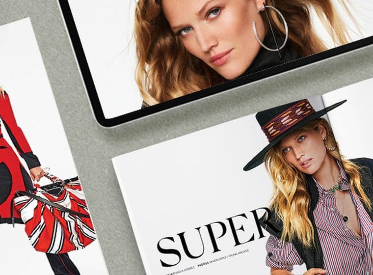 Close-up of magazines and a tablet featuring model Toni Garrn. The GG magazine cover is red and white with a photo of Toni.