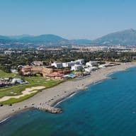 Aerial view of the guadalmina coastline with beach, golf course and luxury properties.