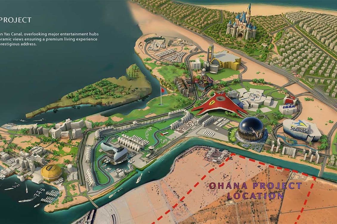 Aerial view of a vibrant entertainment hub with various themed attractions, a race track, and nearby coastal and desert scenery.