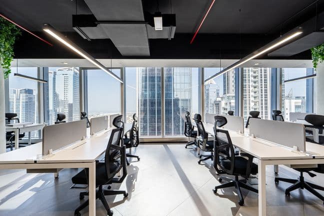 Spacious office floor at Vision Tower with large windows, modern workstations, and abundant natural light