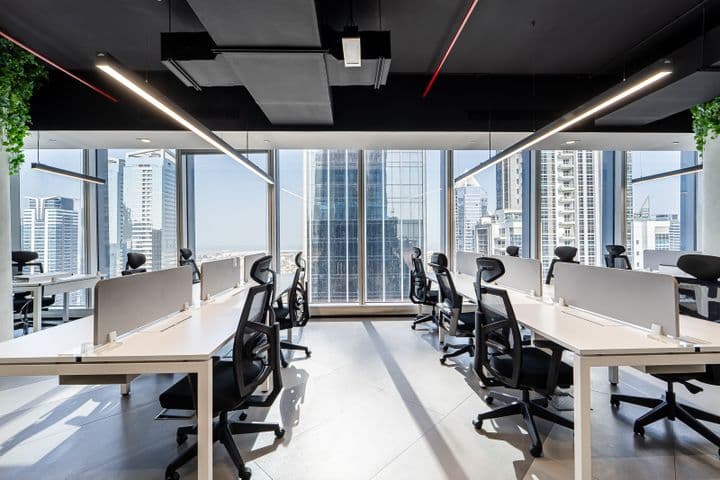 Spacious office floor at Vision Tower with large windows, modern workstations, and abundant natural light
