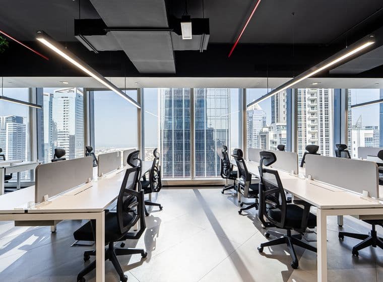 Spacious office floor at Vision Tower with large windows, modern workstations, and abundant natural light